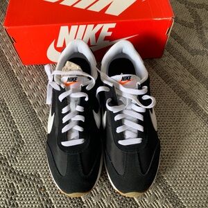 Nike Men's Black and White Sneakers with Orange Accents